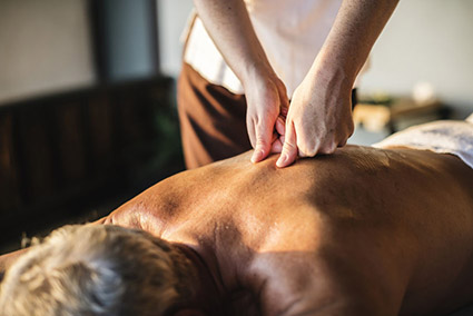Take Advantage of Our Spa Services During Your Stay Man receiving massage